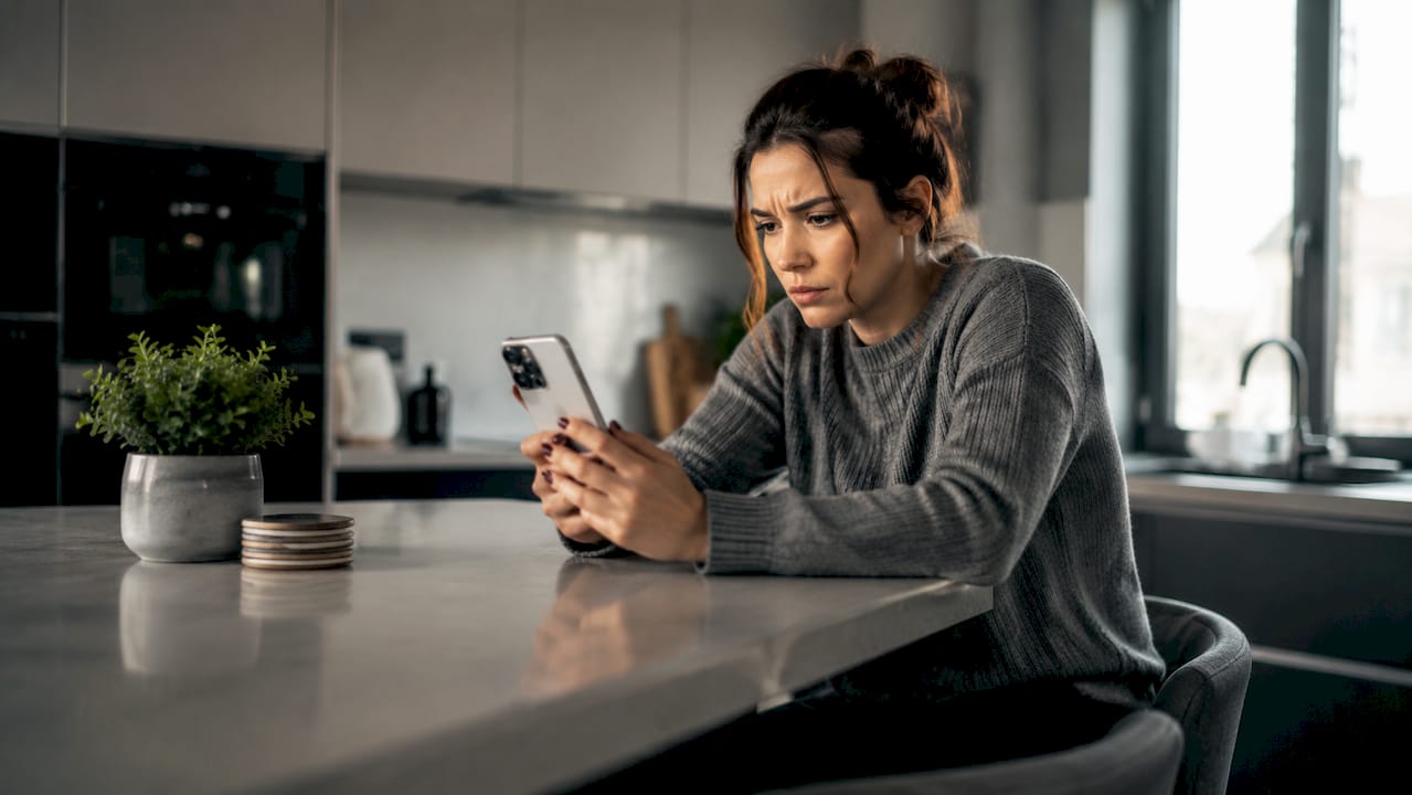Frustrated woman holding iPhone displaying no service
