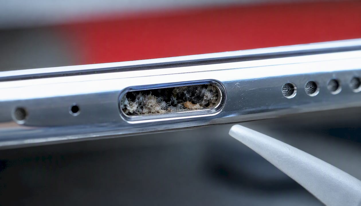 Lint inside smartphone audio port close-up