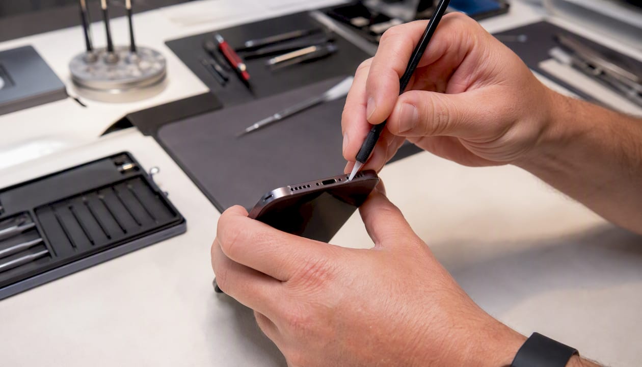 Close-up of cleaning iPhone headphone port
