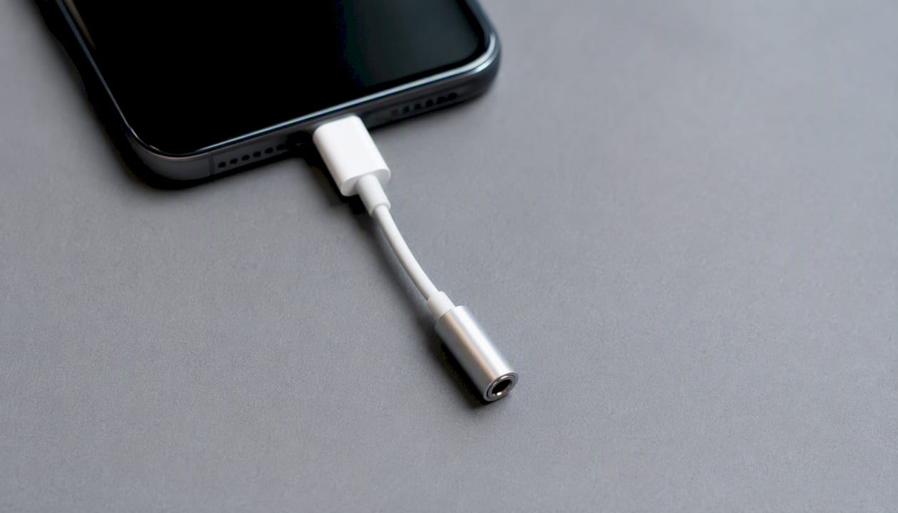 Close-up of headphone adapter plugged into phone