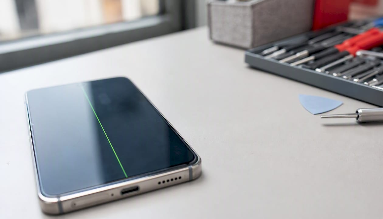 Close-up of smartphone screen with green vertical line