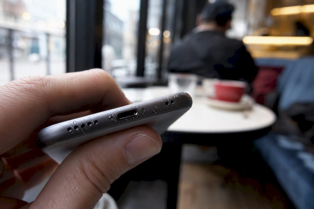 Close-up of water droplets near iPhone charging port