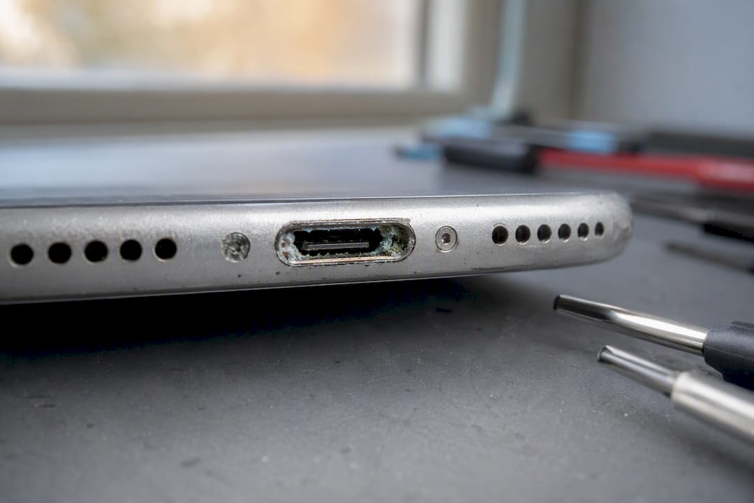 Corrosion inside smartphone charging port close-up