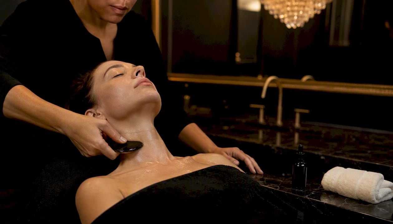 Close-up of facial gua sha on neck and collarbone