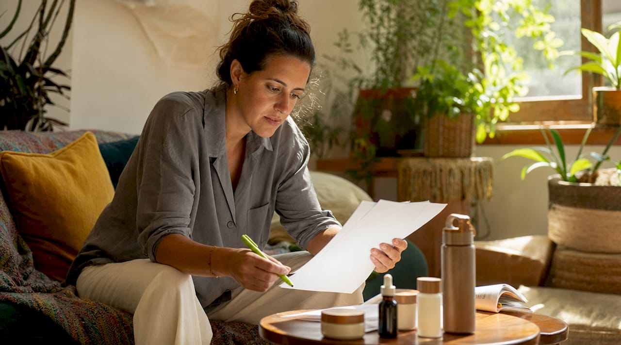 Person reviewing B-Corp beauty certification papers
