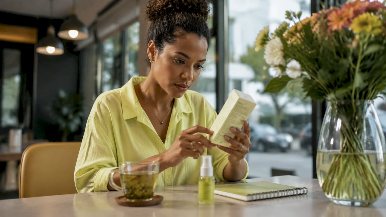 Woman checking beauty product ingredient list