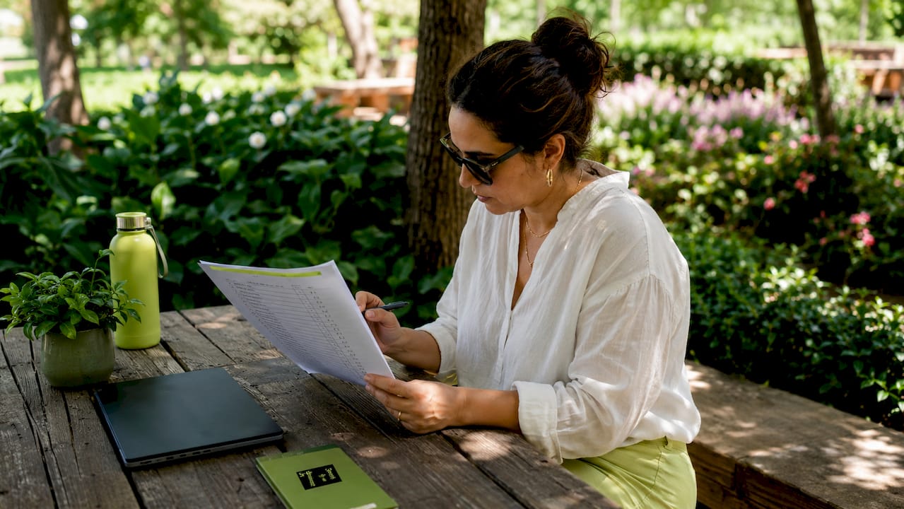 Woman reviewing quality checklist at desk
