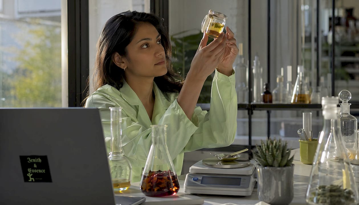 Chemist examining upcycled oil extract in lab