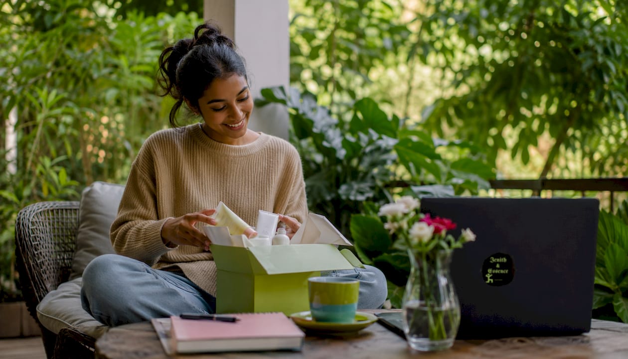 Woman unboxing curated beauty products at home