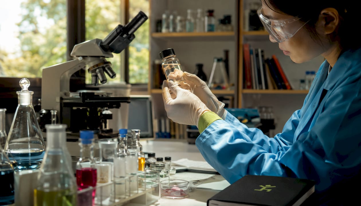 Scientist examining microplastics in skin sample