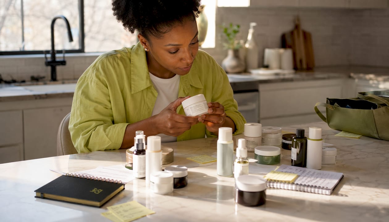 Person inspecting skincare expiration dates