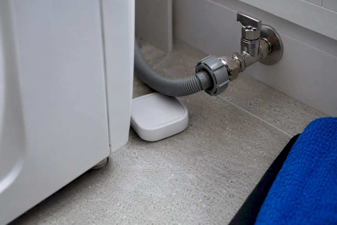 Leak sensor beside washing machine hose