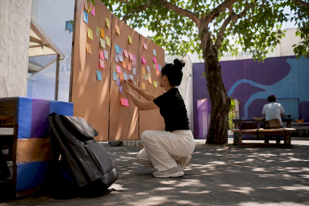 Hand placing sticky notes on purpose timeline