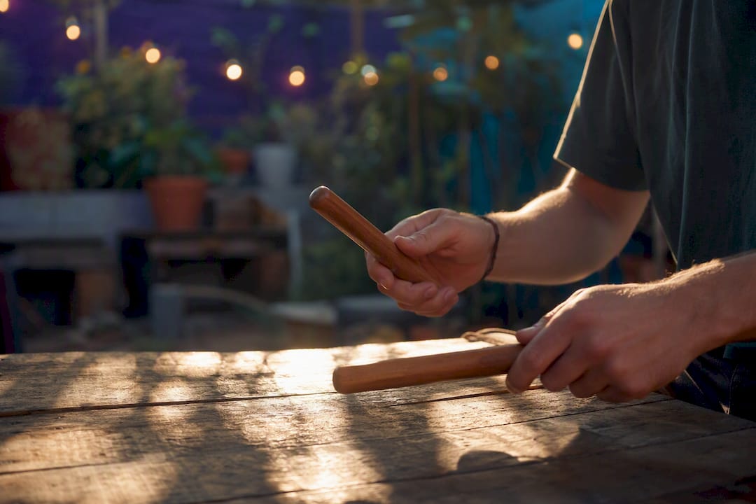 Hands tapping rhythm sticks in studio