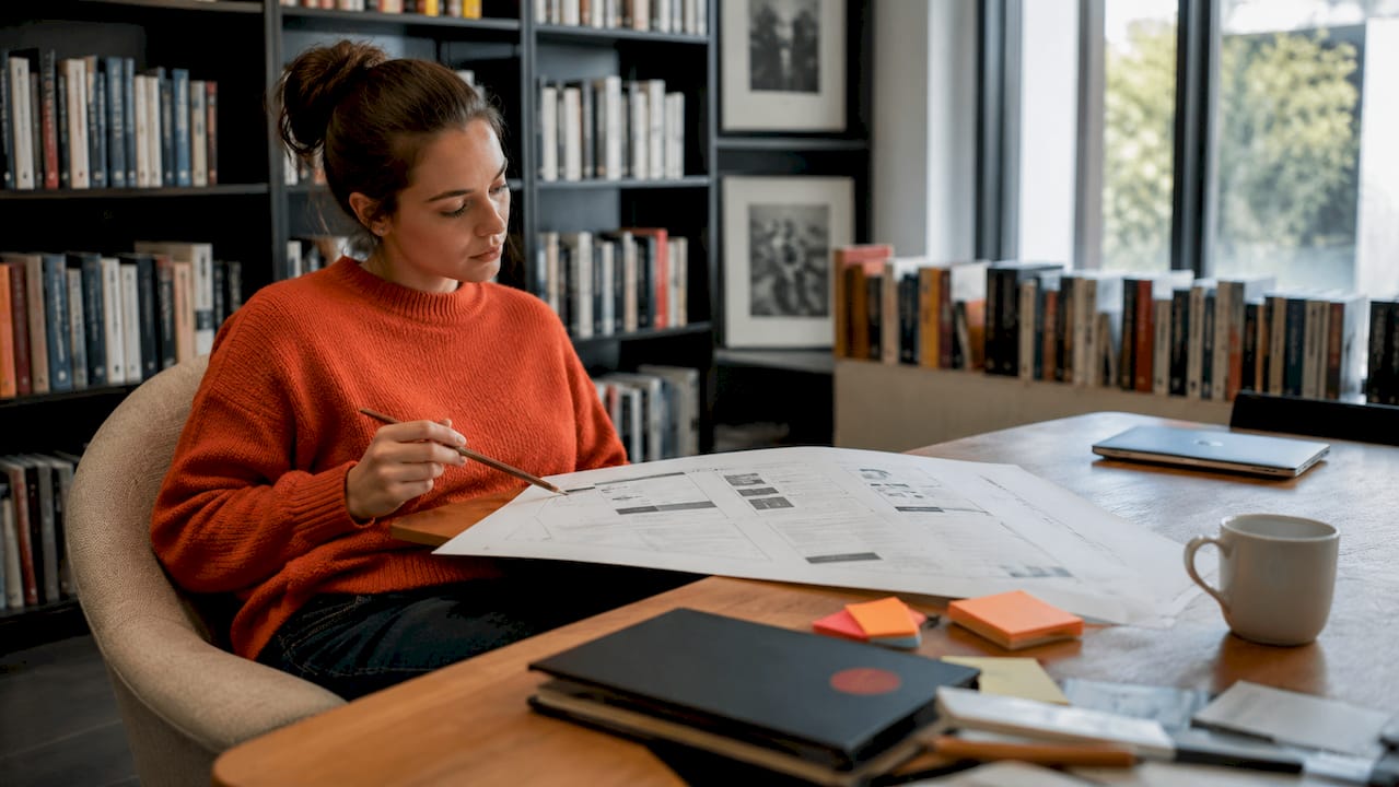 UX designer checking white space on printed layout UX designer checking white space on printed layout