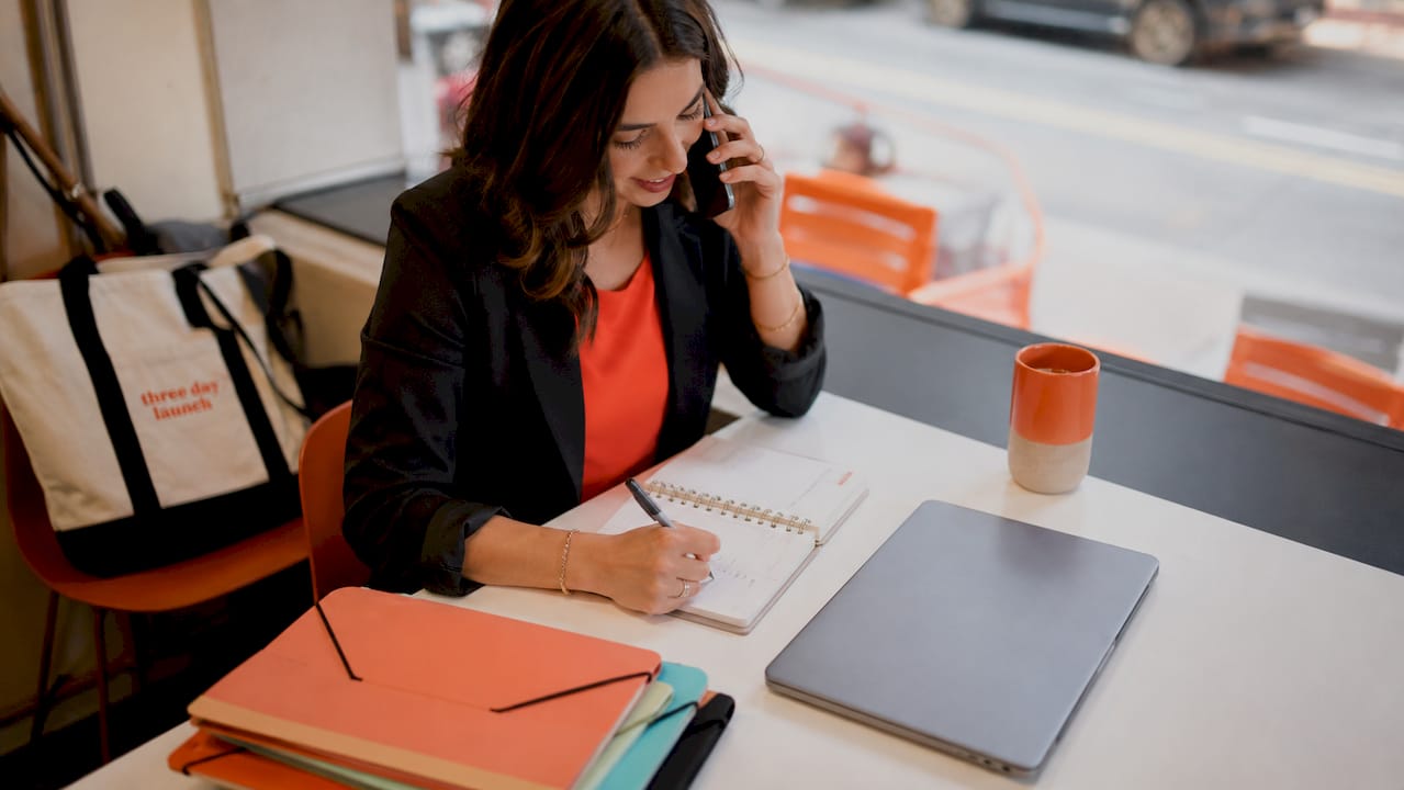 Small business owner requesting a client testimonial by phone to boost website credibility