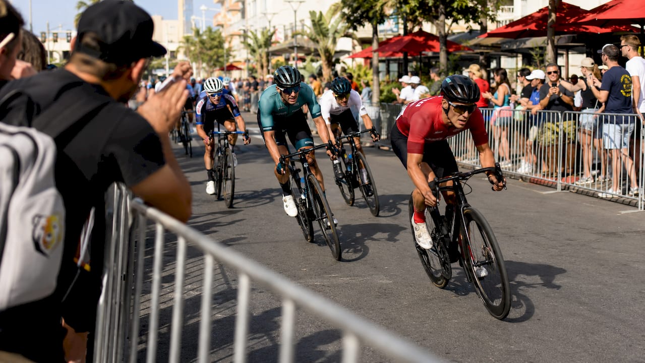 Outdoor criterium race with cyclists turning corner