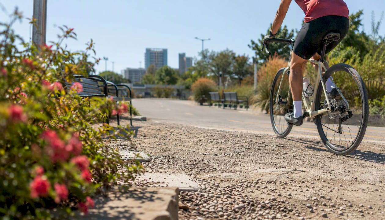 Cyclist on urban mixed paved-gravel trail
