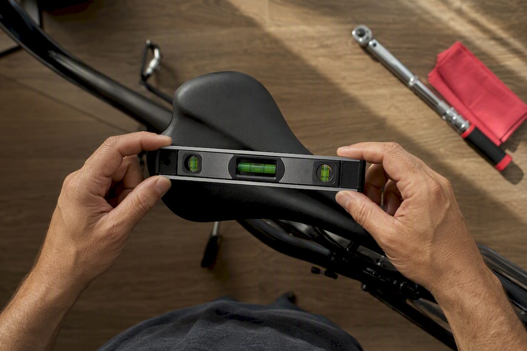 Spirit level resting across bicycle saddle