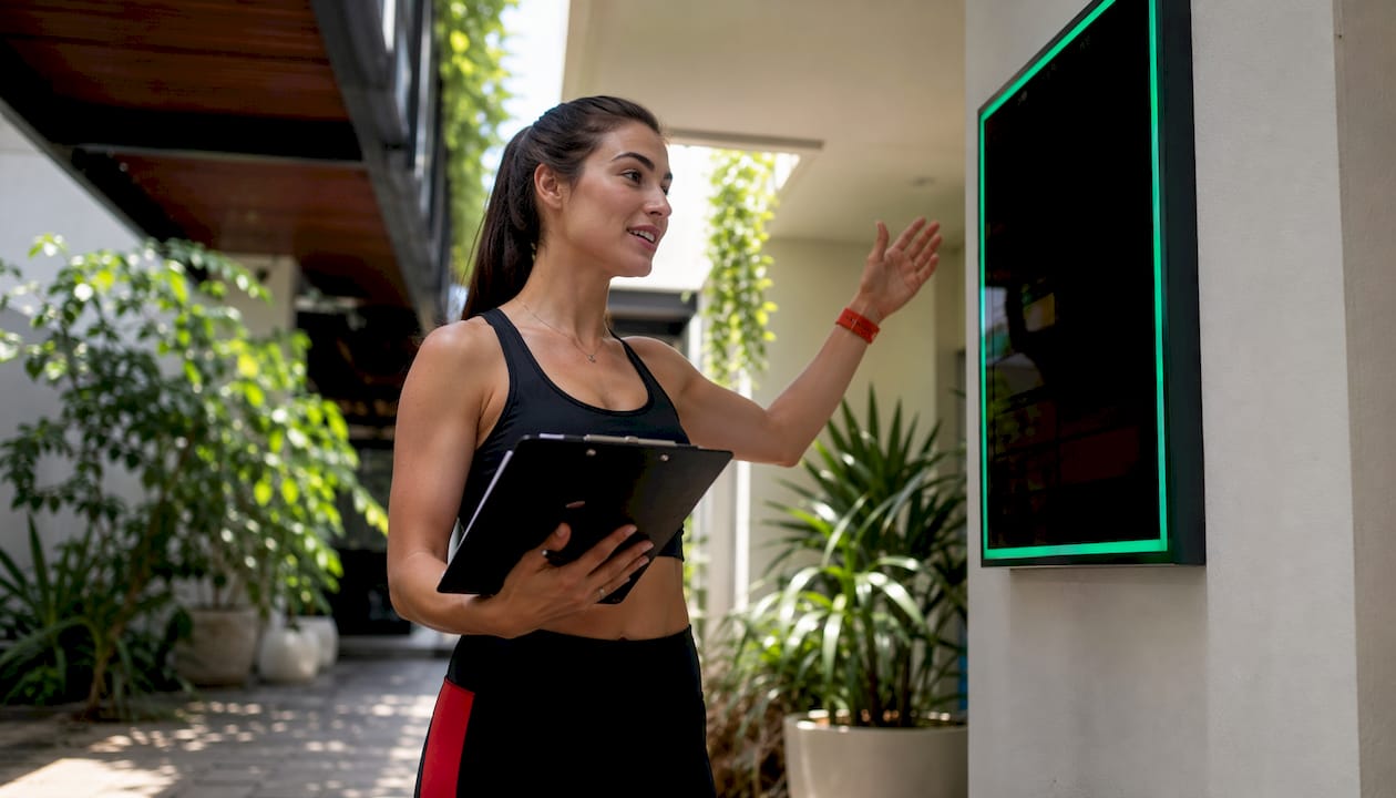Instructor reviewing studio door schedule panel