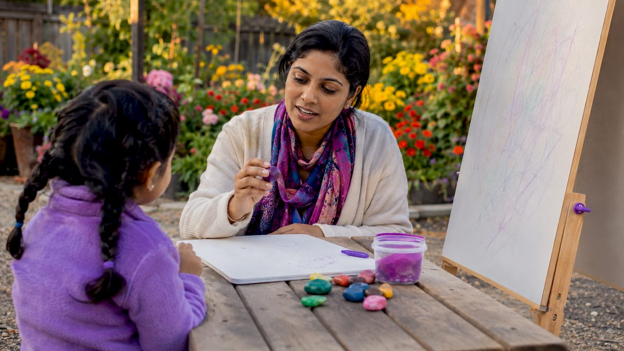 Educator demonstrating tactile writing tools