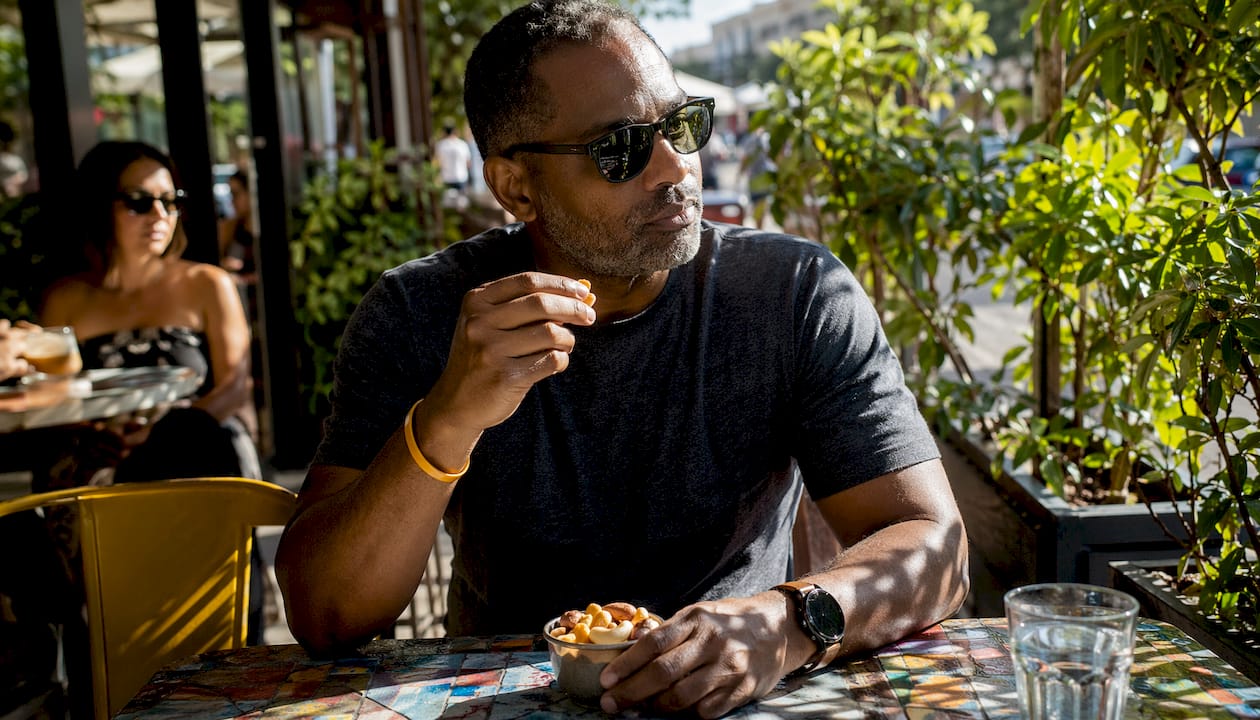 Man eating protein-rich snack during work