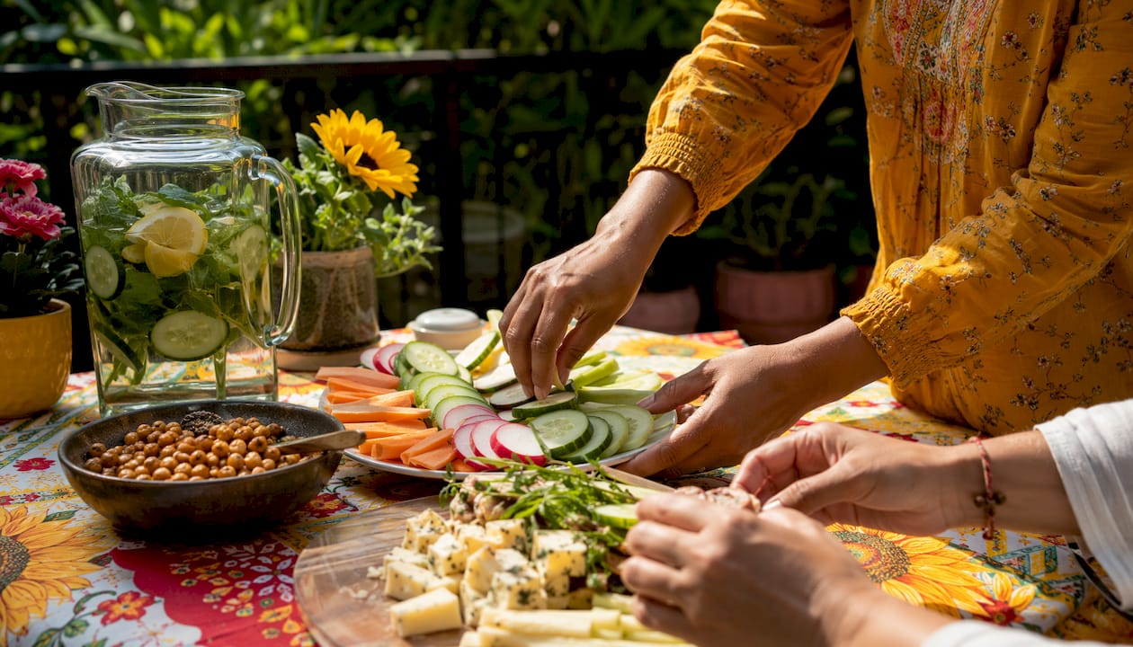 Hands preparing protein plus produce snack plate