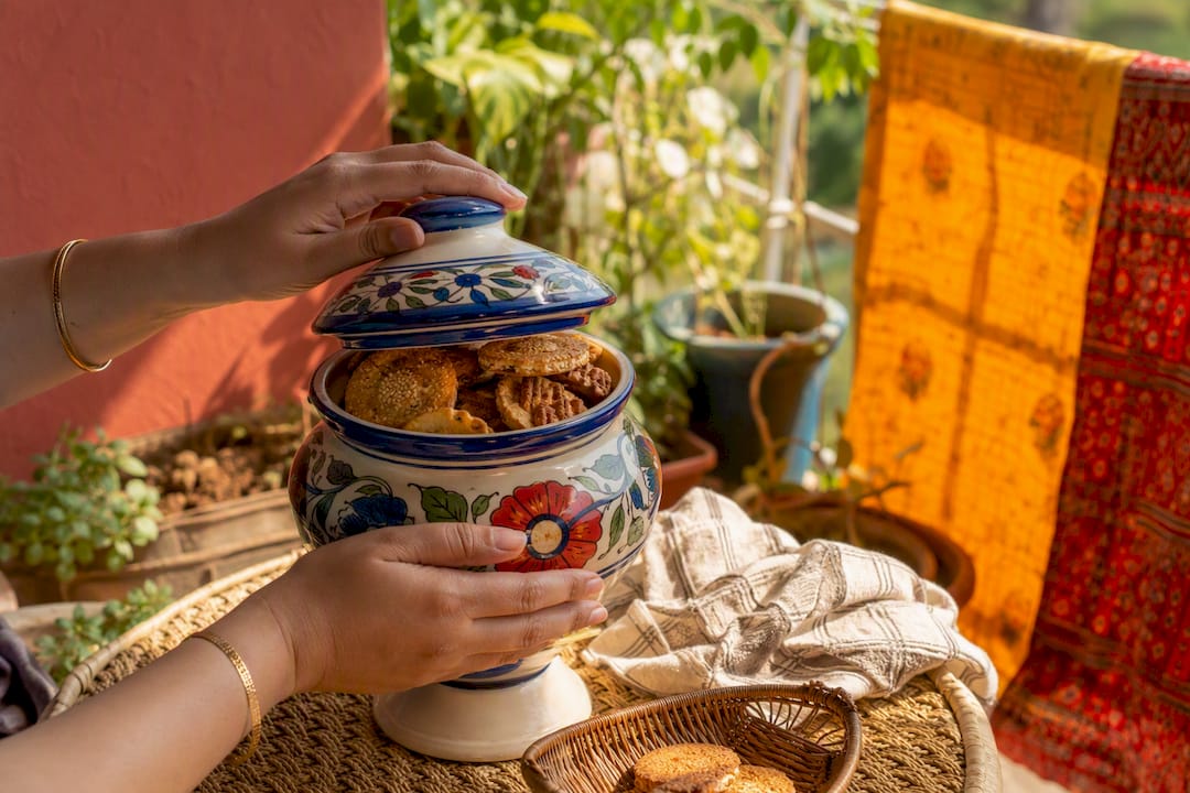 Hand sealing jar of Indian biscuits