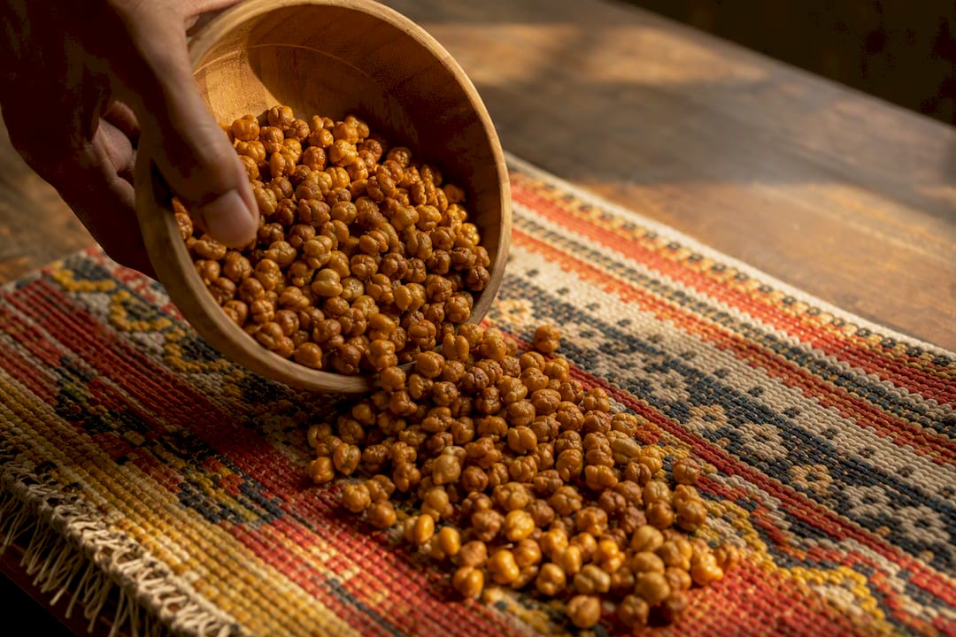 Hand sprinkling roasted chana on cloth