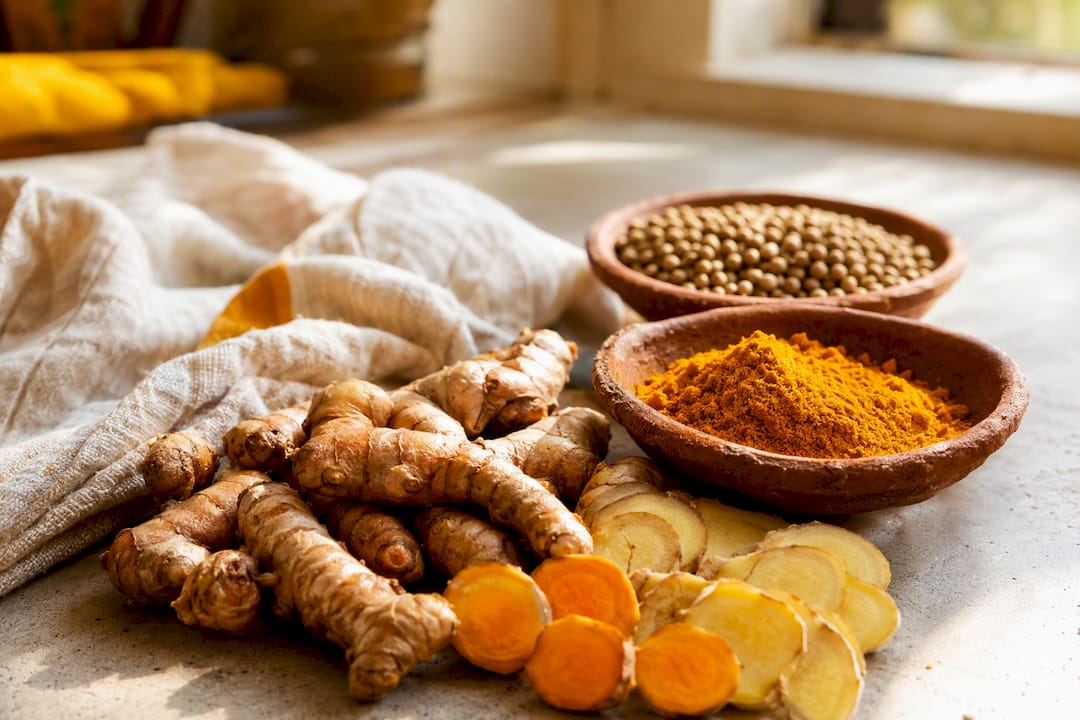 Turmeric and ginger spices on wooden table