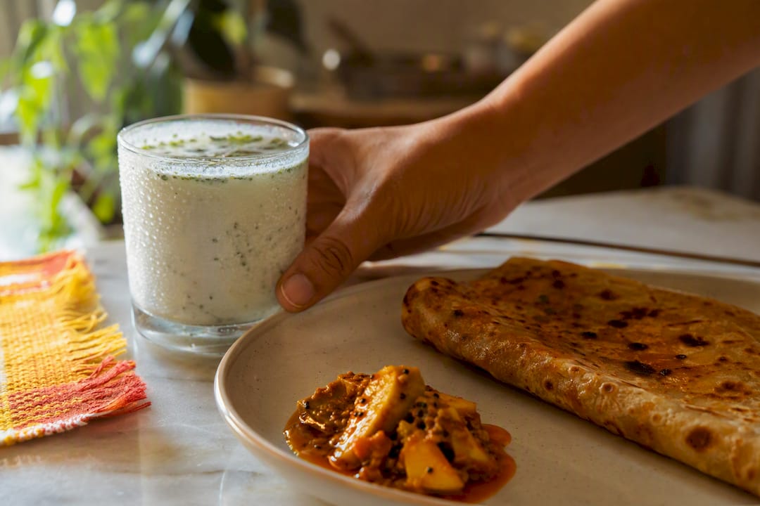 Chaas with paratha and mango pickle