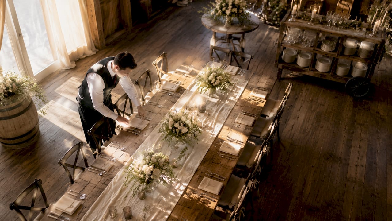 Wedding venue staff preparing dining room