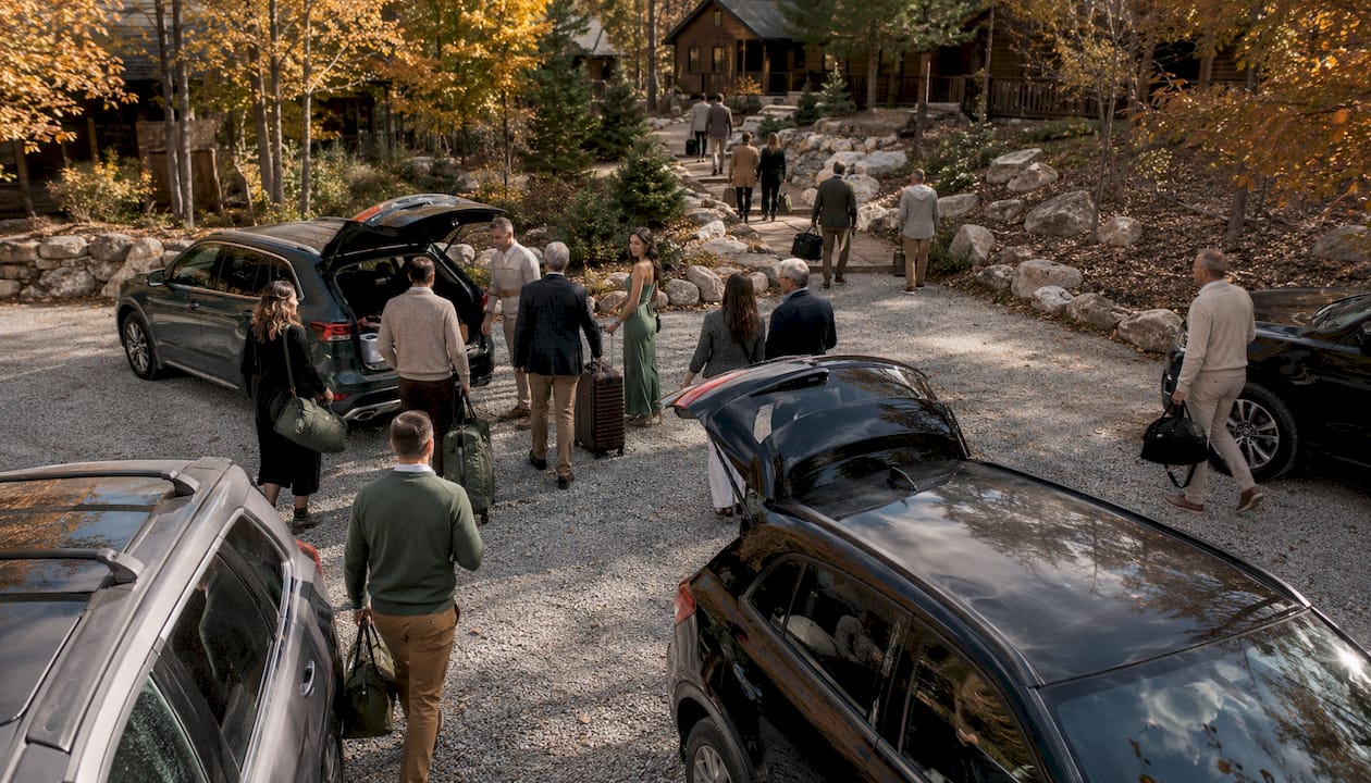 Wedding guests unloading luggage at mountain venue