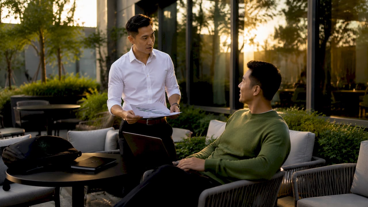 Professionals discussing vCISO strategy documents
