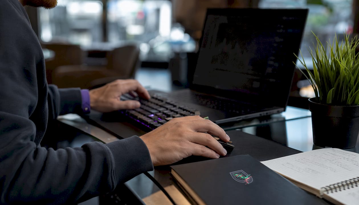 Trader’s hands adjusting settings at desk