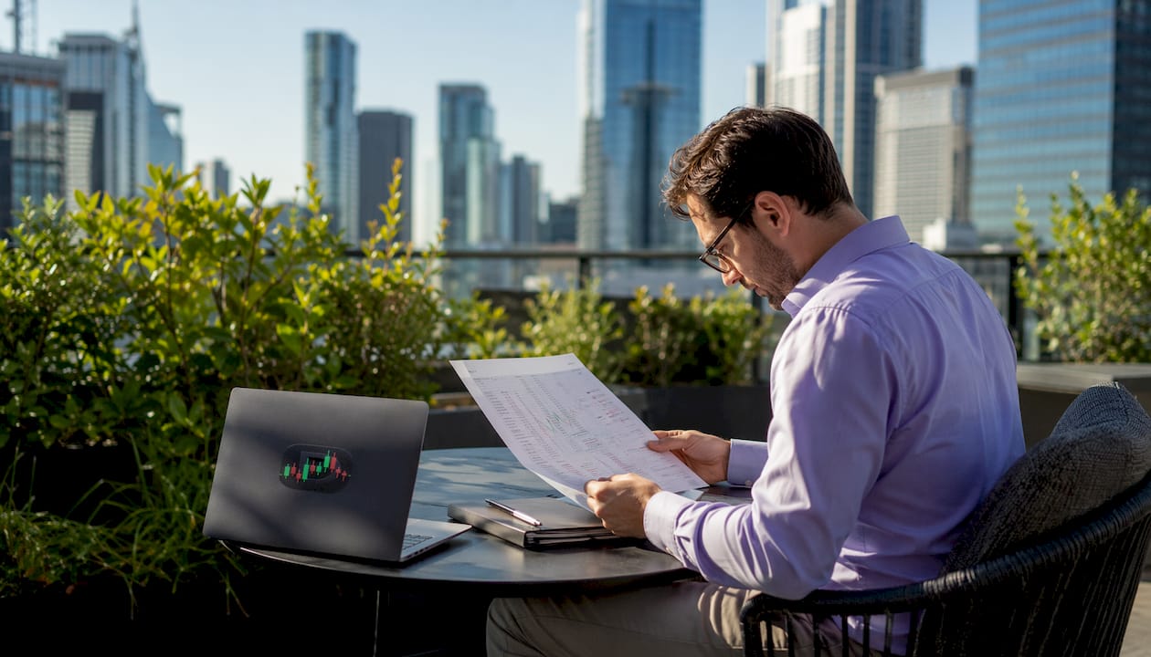 Trader reviewing printed profit factor spreadsheet