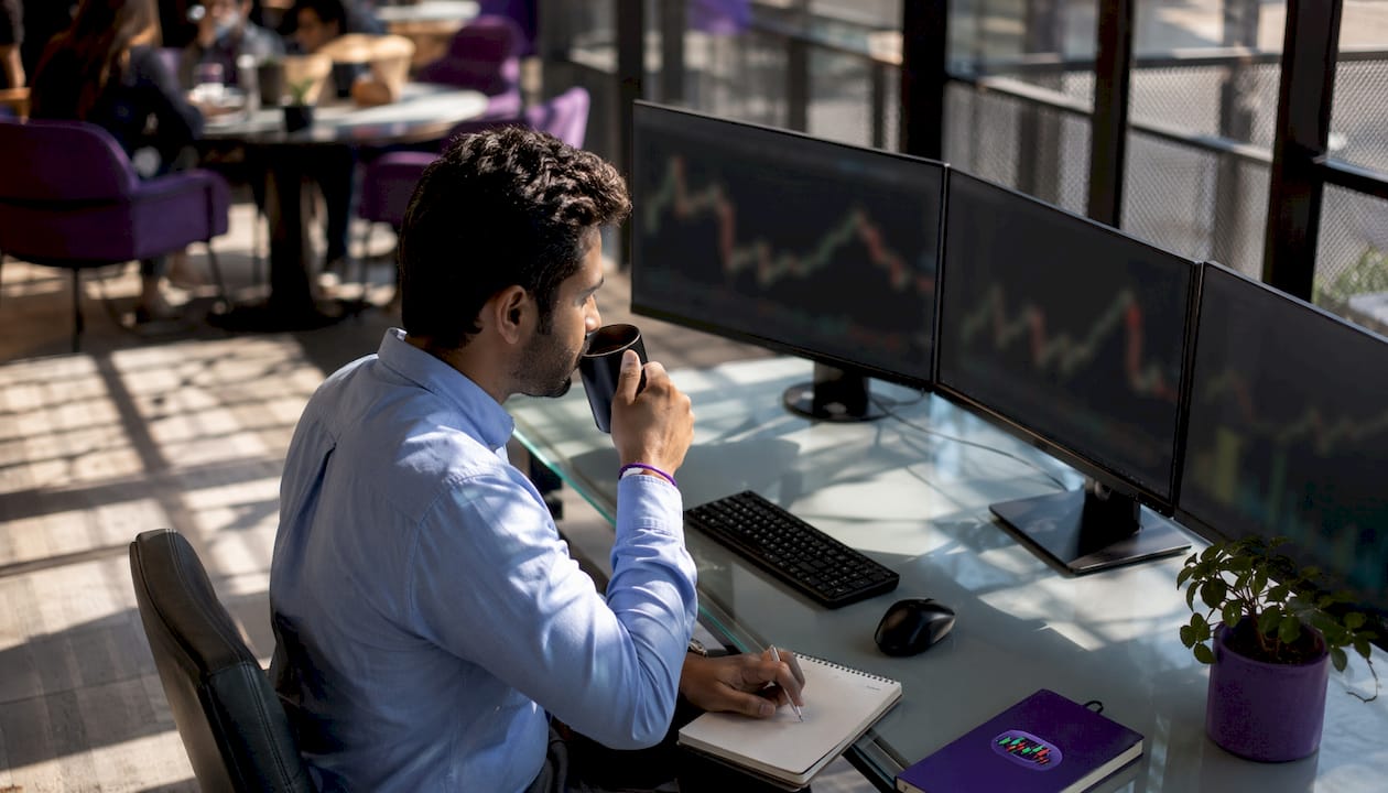 Trader analyzing staged entries on screens