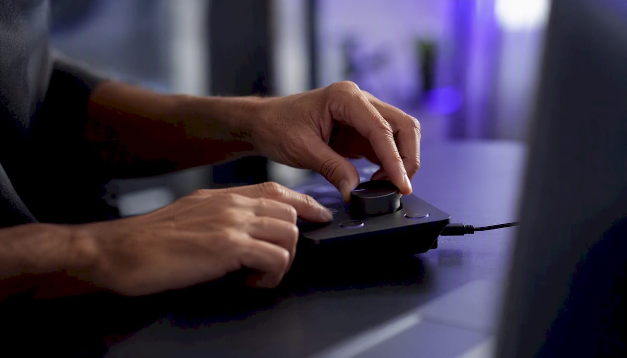 Trader's hands adjusting trading device controls