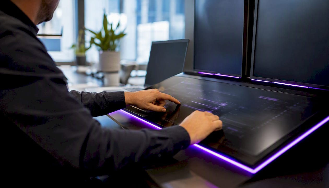 Hands adjusting trading console controls