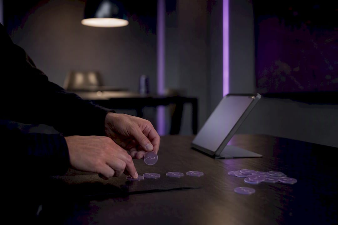 Hands placing trade outcome tag tokens