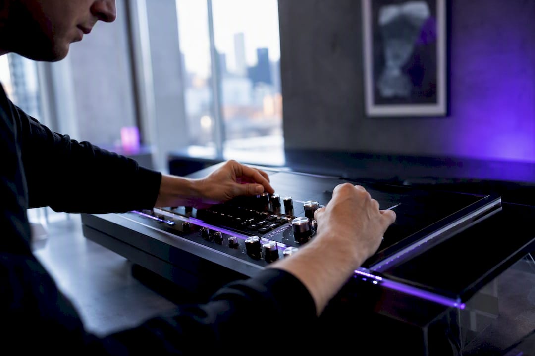Hands adjusting trading control dials