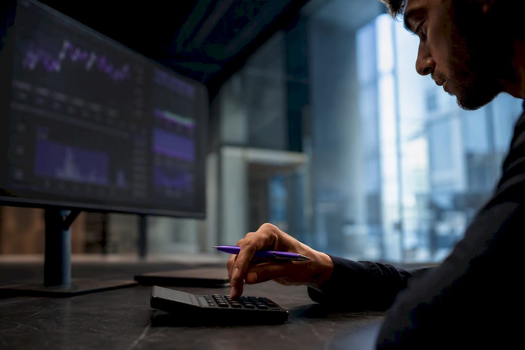 Trader calculating risk-adjusted position size