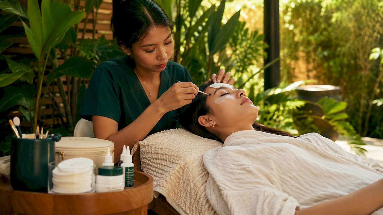 Lash artist applying lifting solution carefully