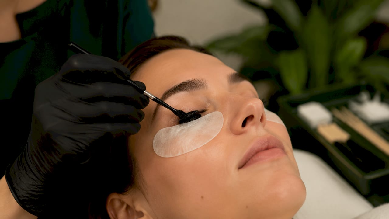 Close-up of lash tint dye application on eyelashes