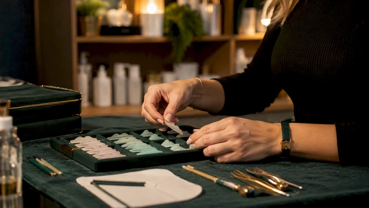 Hands selecting silicone lash lift shields
