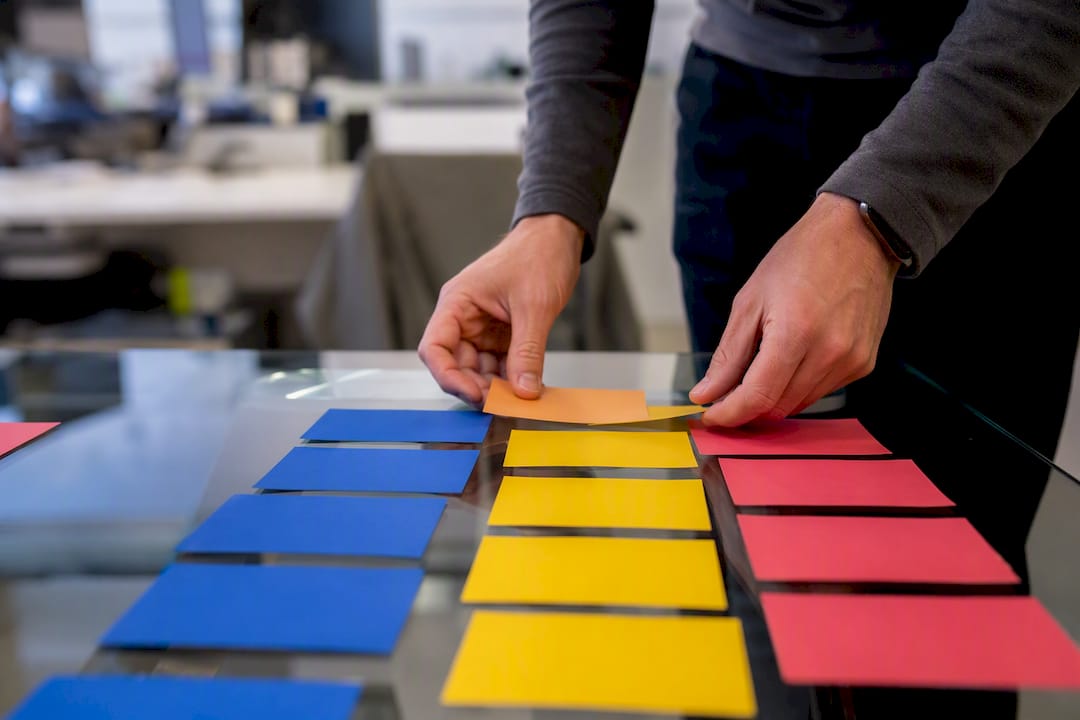 Hands arranging bug report workflow cards