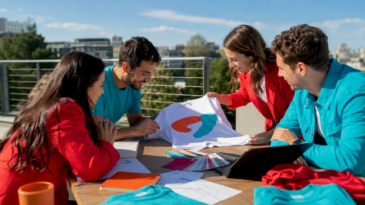 Colleagues collaborating wearing branded team apparel