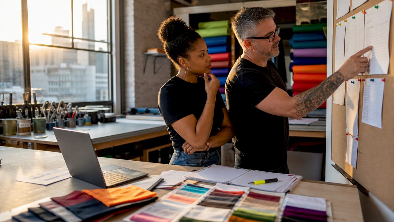 Hands comparing screen printing cost quotes