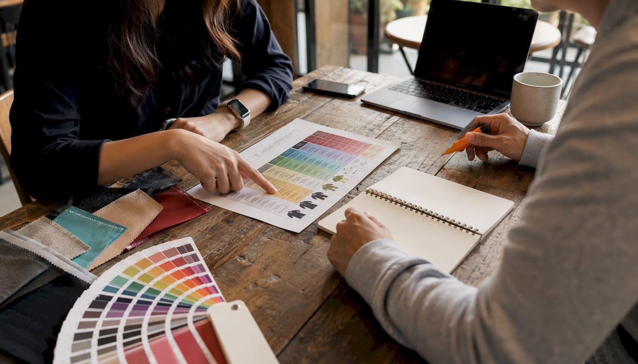 Hands discussing custom printing service chart