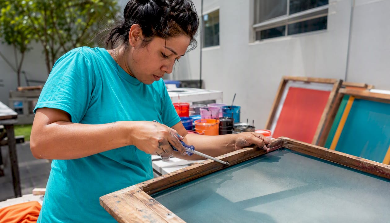 Hands tightening screen printing mesh frame